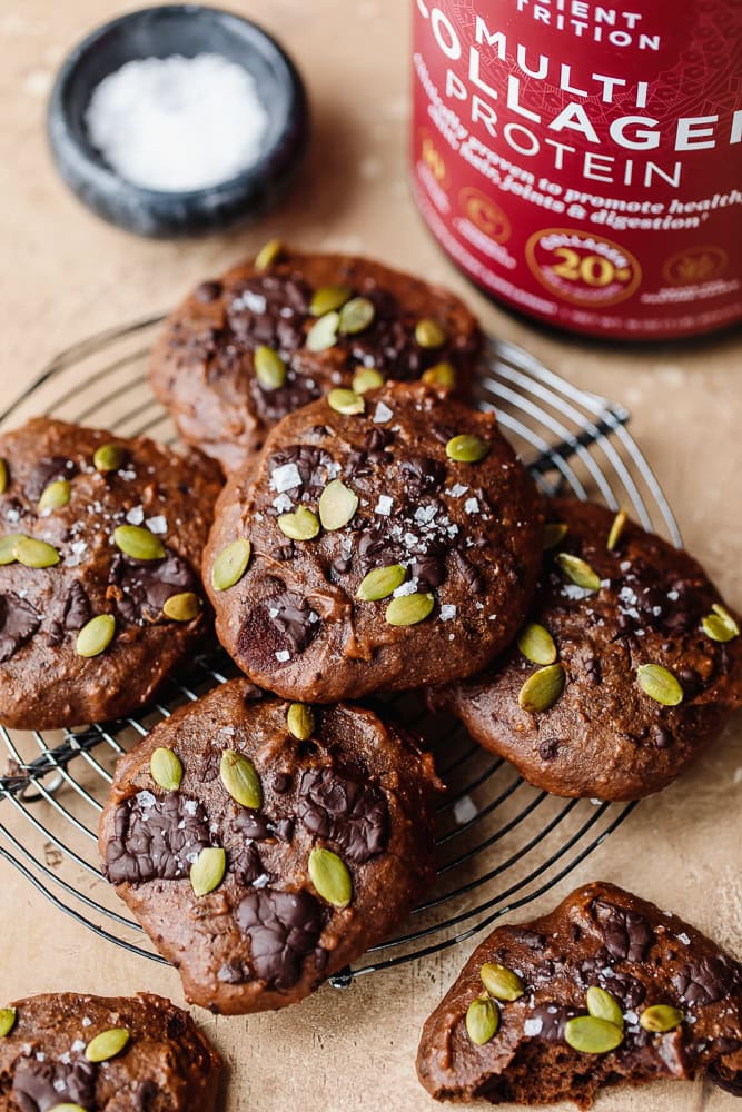 Delight Fuel protein cookies with pumpkin seeds and chocolate chips on a cooling rack.