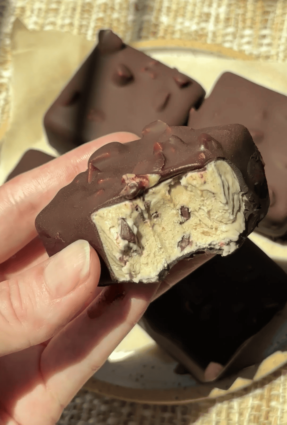 Close-up of Delight Fuel chocolate bar with nuts and creamy filling.