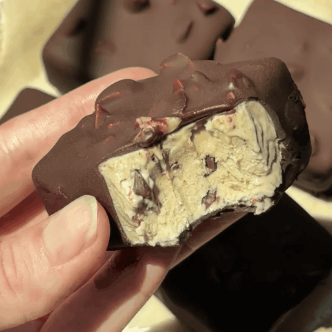 Close-up of Delight Fuel chocolate bar with nuts and creamy filling.