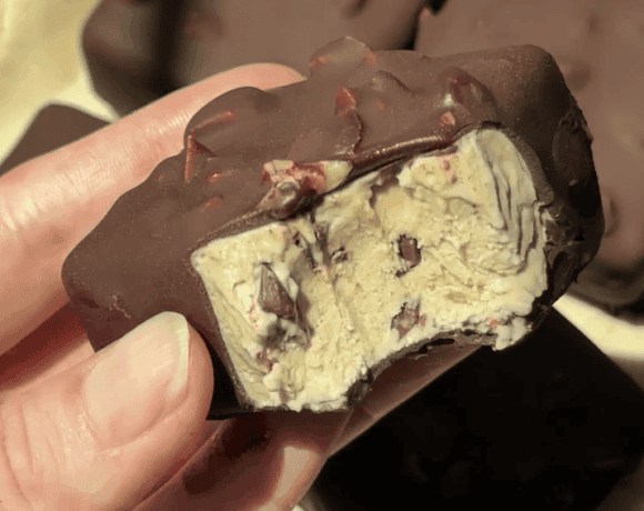 Close-up of Delight Fuel chocolate bar with nuts and creamy filling.
