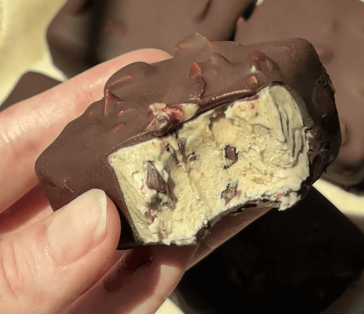 Close-up of Delight Fuel chocolate bar with nuts and creamy filling.