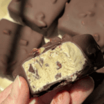 Chocolate-covered ice cream bars with creamy filling and nuts.