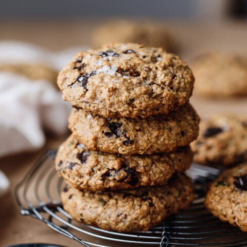 Stack of freshly baked chocolate chip cookies on a cooling rack.