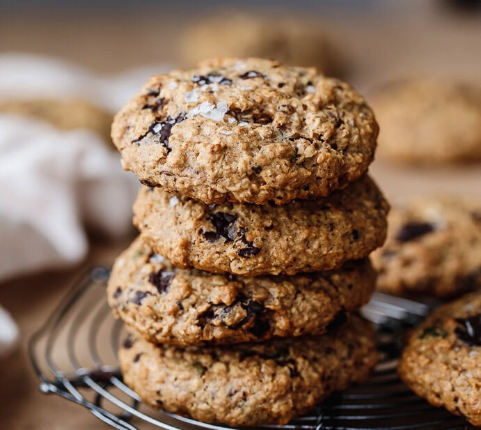 Stack of freshly baked chocolate chip cookies on a cooling rack.