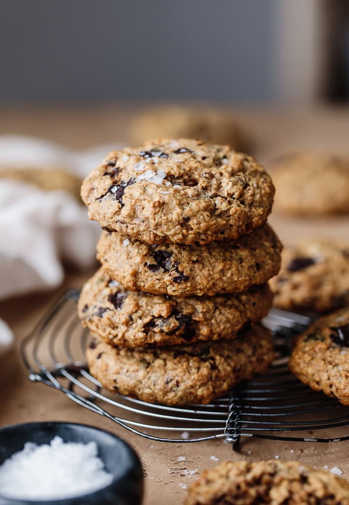 Stack of freshly baked chocolate chip cookies on a cooling rack.