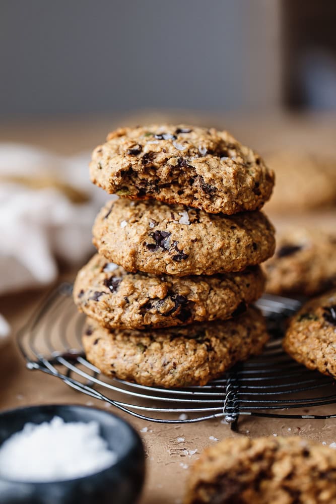 Stack of freshly baked chocolate chip cookies on a cooling rack.
