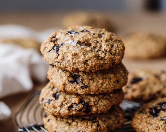 Stack of healthy protein breakfast cookies with chocolate chips on cooling rack.