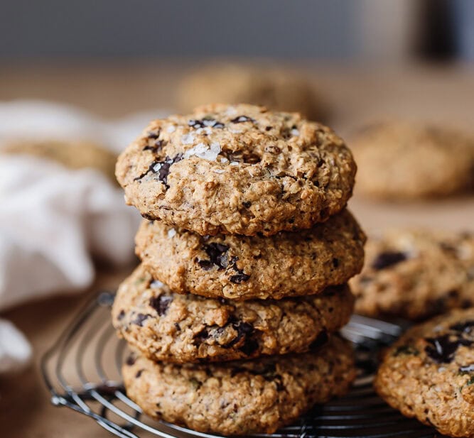 Stack of healthy protein breakfast cookies with chocolate chips on cooling rack.