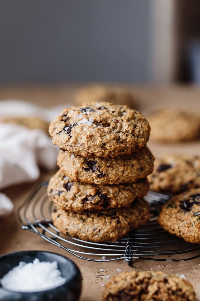 Stack of healthy protein breakfast cookies with chocolate chips on cooling rack.